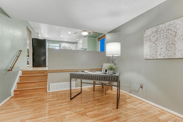 15918 E Flora Pl, Aurora, CO 80013 - office featuring light wood-style flooring, a textured wall, baseboards, ceiling fan, and a textured ceiling
