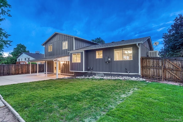15918 E Flora Pl, Aurora, CO 80013 - back of house featuring board and batten siding, a patio area, and a gate