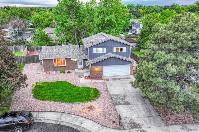 15918 E Flora Pl, Aurora, CO 80013 - split level home with brick siding, concrete driveway, a garage, and board and batten siding