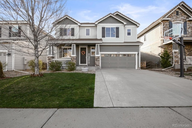 craftsman-style house featuring a garage, covered porch, concrete driveway, a front yard, and stone siding
