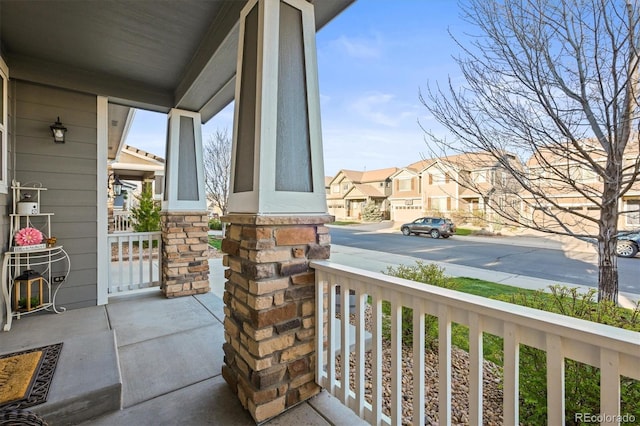 view of patio featuring covered porch and a residential view