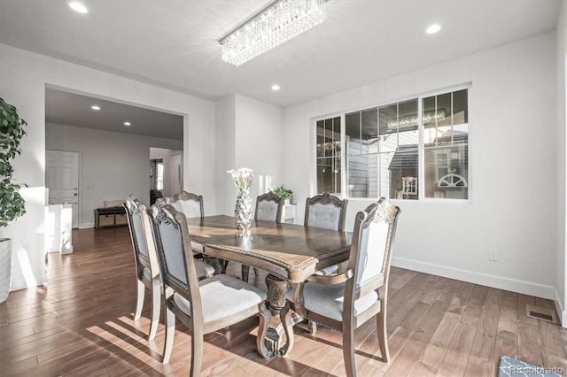 dining space featuring wood finished floors, recessed lighting, and baseboards