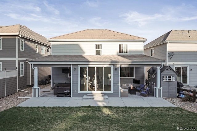 rear view of property featuring an outdoor living space, entry steps, a patio, and a hot tub