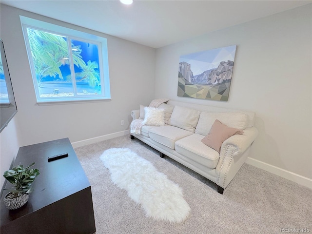 carpeted living room with baseboards