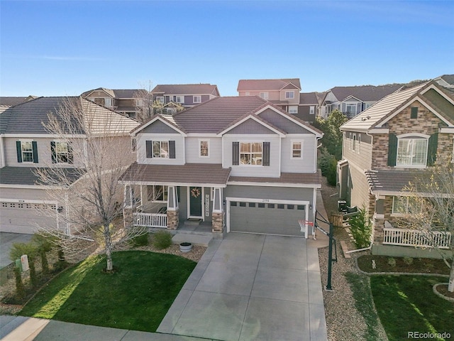 view of front of property with an attached garage, a porch, driveway, a residential view, and stone siding