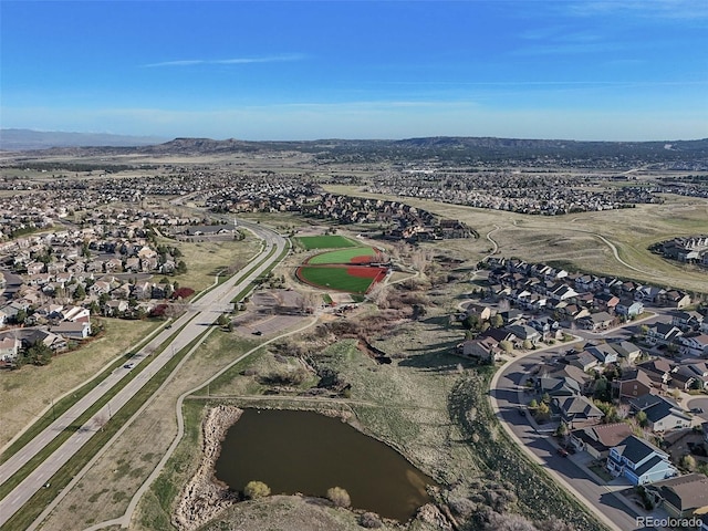 aerial overview of property's location featuring nearby suburban area and a water and mountain view