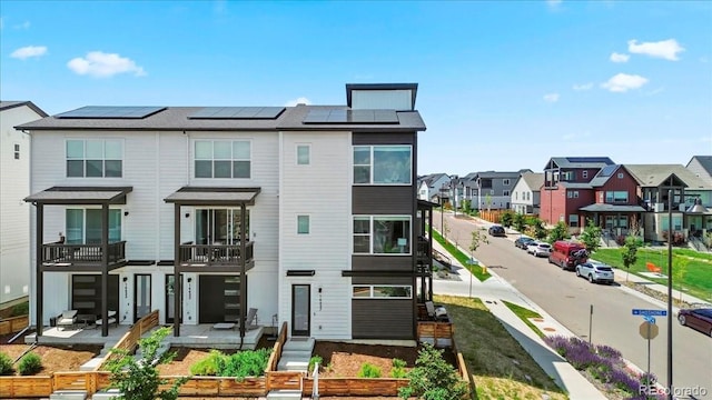 16637 Shoshone St, Broomfield, CO 80023 - rear view of house with a residential view, roof mounted solar panels, and a balcony