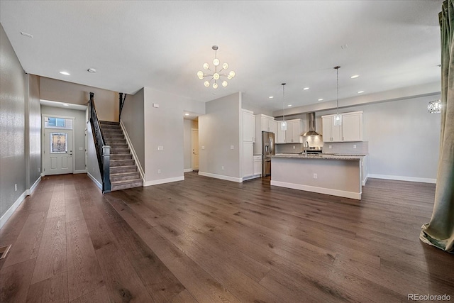 unfurnished living room featuring dark wood-type flooring, sink, and a chandelier