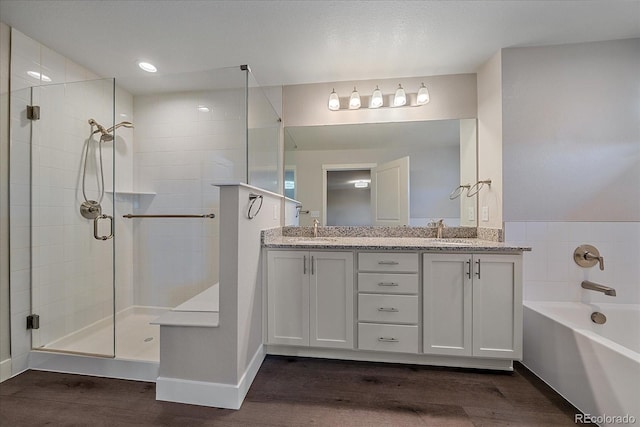 bathroom with vanity, hardwood / wood-style flooring, and shower with separate bathtub