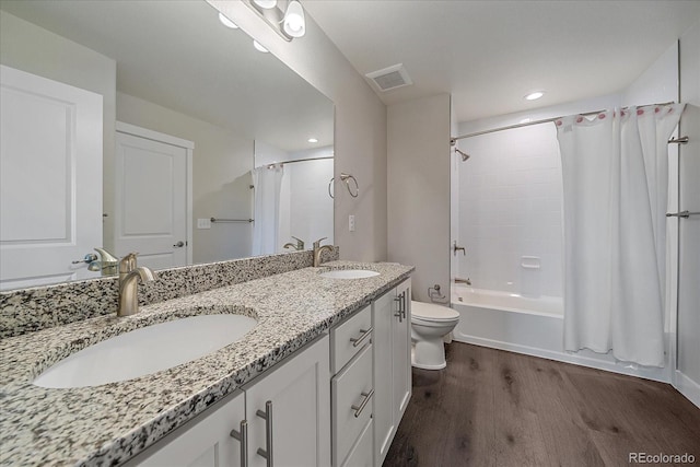 full bathroom with vanity, hardwood / wood-style floors, shower / bath combination with curtain, and toilet