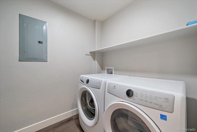 laundry room with washer and dryer, electric panel, and dark hardwood / wood-style floors