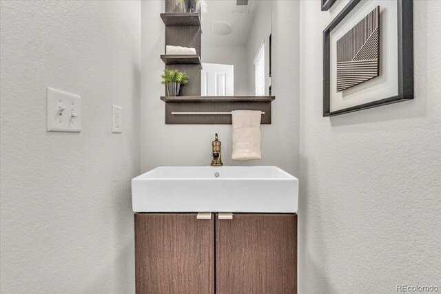 3372 Central Park Blvd, Denver, CO 80238 - bathroom featuring a textured wall and vanity