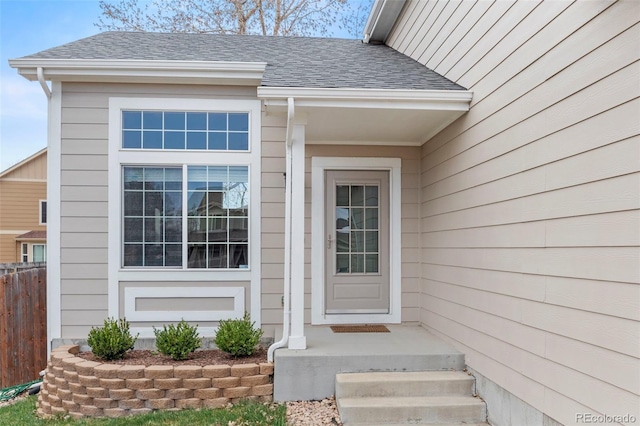 4426 Crow Creek Dr, Colorado Springs, CO 80922 - view of exterior entry with fence and a shingled roof