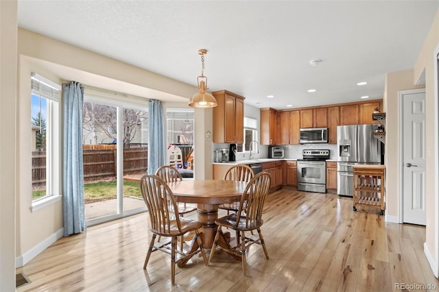 4426 Crow Creek Dr, Colorado Springs, CO 80922 - dining space with light wood finished floors, baseboards, and recessed lighting