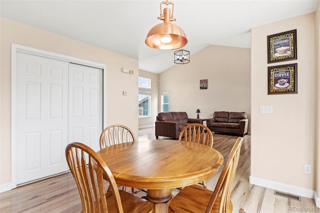 4426 Crow Creek Dr, Colorado Springs, CO 80922 - dining area with light wood-style flooring, baseboards, and vaulted ceiling