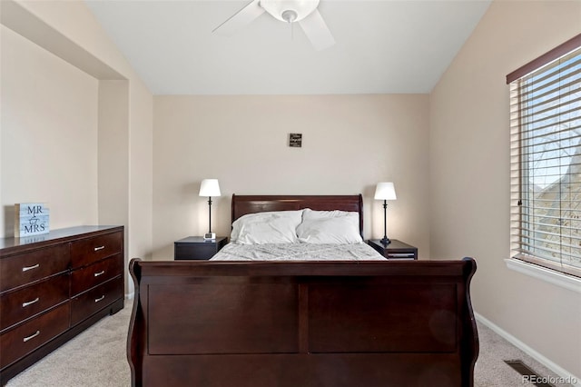 4426 Crow Creek Dr, Colorado Springs, CO 80922 - bedroom with light colored carpet, multiple windows, baseboards, and ceiling fan
