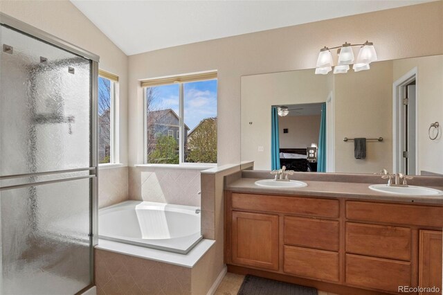 4426 Crow Creek Dr, Colorado Springs, CO 80922 - ensuite bathroom featuring a shower stall, a bath, double vanity, and vaulted ceiling