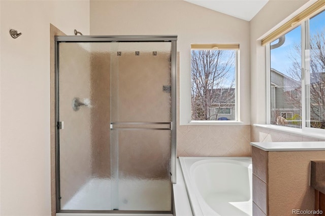 4426 Crow Creek Dr, Colorado Springs, CO 80922 - bathroom with a shower stall, vaulted ceiling, and a garden tub