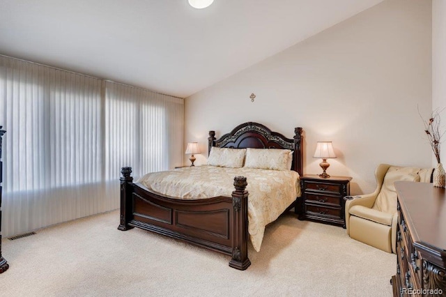 carpeted bedroom with lofted ceiling