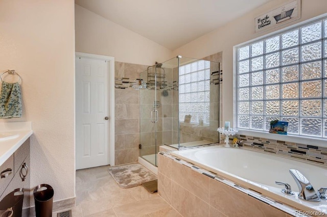 bathroom with vanity, tile patterned flooring, plus walk in shower, and vaulted ceiling