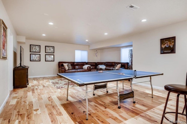 rec room with light hardwood / wood-style floors