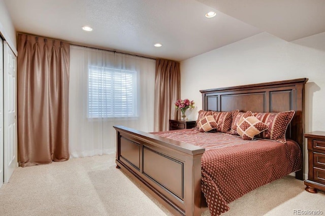 bedroom featuring a closet and light colored carpet