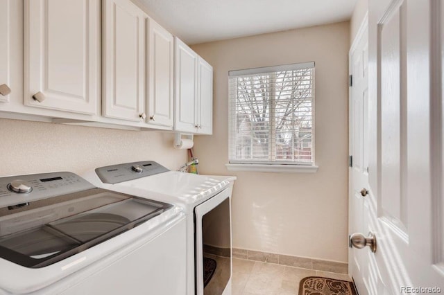 washroom featuring cabinets, independent washer and dryer, and light tile patterned flooring