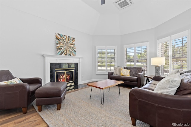 2370 W 152nd Ave, Broomfield, CO 80023 - living area with wood finished floors, plenty of natural light, a premium fireplace, ceiling fan, and a towering ceiling