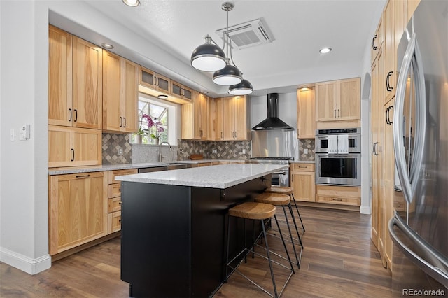 2370 W 152nd Ave, Broomfield, CO 80023 - kitchen featuring stainless steel appliances, wall chimney exhaust hood, light brown cabinetry, backsplash, and recessed lighting
