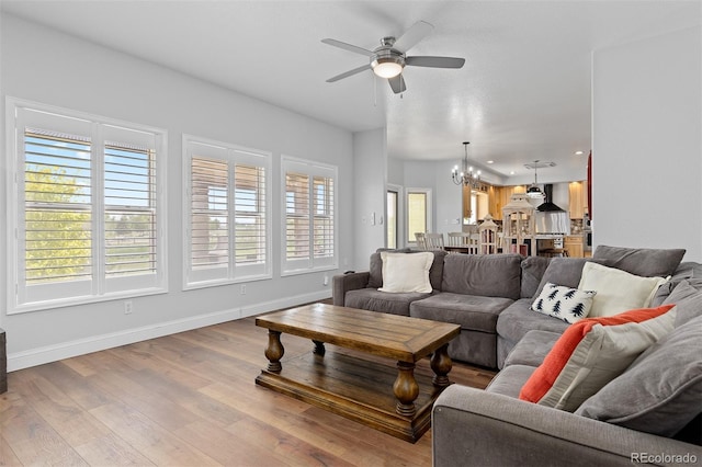 2370 W 152nd Ave, Broomfield, CO 80023 - living area featuring a chandelier, healthy amount of natural light, a ceiling fan, wood finished floors, and recessed lighting
