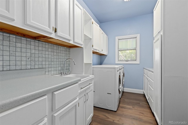 2370 W 152nd Ave, Broomfield, CO 80023 - washroom featuring cabinet space, washing machine and dryer, and dark wood-type flooring