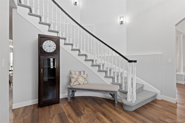 2370 W 152nd Ave, Broomfield, CO 80023 - staircase featuring wood finished floors and a towering ceiling