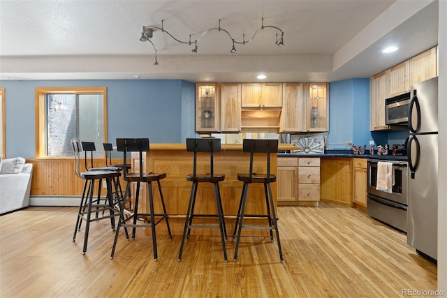 2370 W 152nd Ave, Broomfield, CO 80023 - kitchen with stainless steel appliances, light brown cabinets, light wood finished floors, dark countertops, and recessed lighting