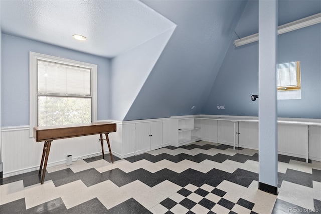 2370 W 152nd Ave, Broomfield, CO 80023 - additional living space with plenty of natural light, a wainscoted wall, tile patterned floors, and a textured ceiling