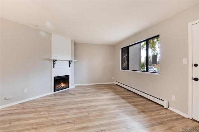 unfurnished living room featuring baseboard heating and light hardwood / wood-style flooring