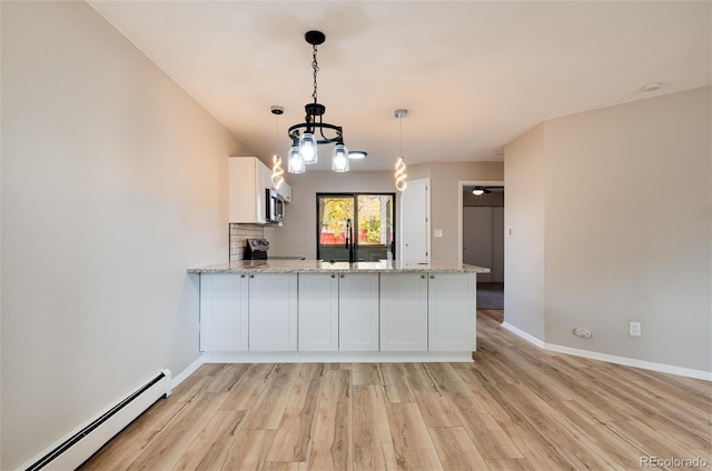 kitchen featuring stainless steel appliances, white cabinetry, kitchen peninsula, a baseboard radiator, and light wood-type flooring