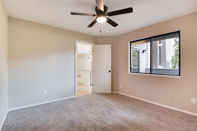 empty room with light carpet and ceiling fan