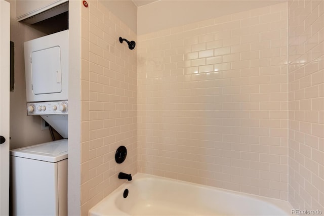 bathroom featuring tiled shower / bath combo and stacked washer / drying machine