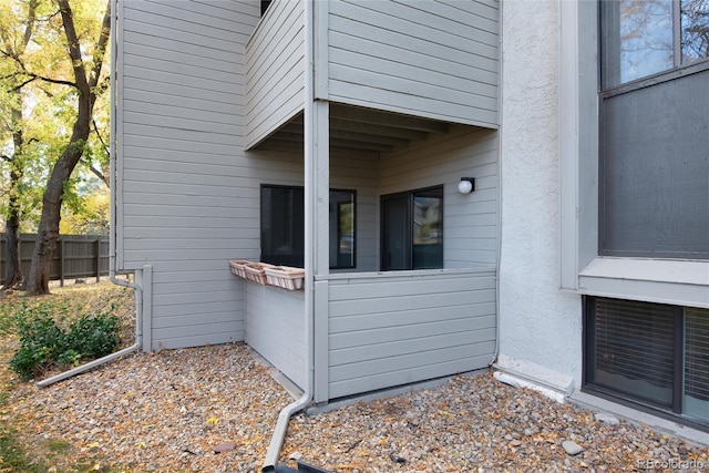 view of home's exterior featuring fence