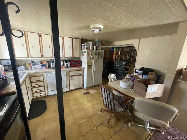 189 13th Ave, Cedaredge, CO 81413 - kitchen featuring a textured ceiling, white appliances, light floors, and light countertops