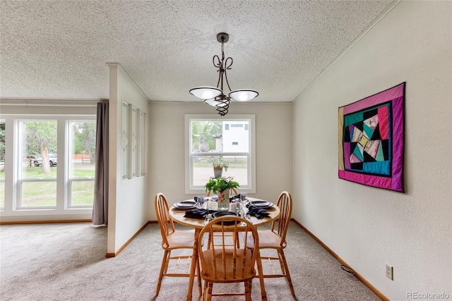 910 W Main St, Buena Vista, CO 81211 - dining room with light carpet, a textured ceiling, and a chandelier
