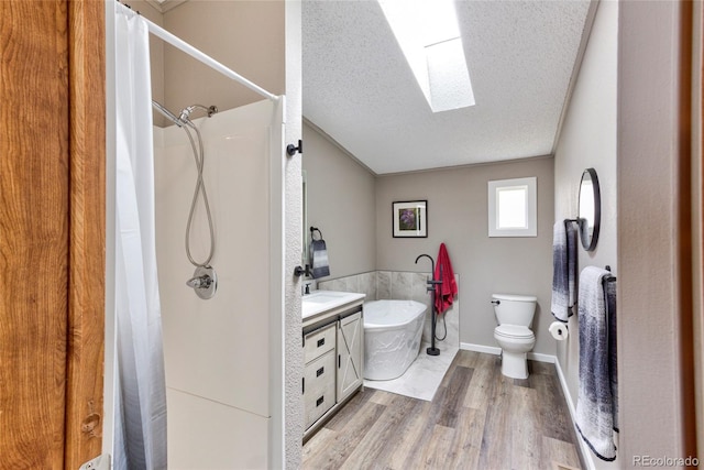 910 W Main St, Buena Vista, CO 81211 - bathroom with a textured ceiling, wood finished floors, a freestanding tub, vanity, and curtained shower