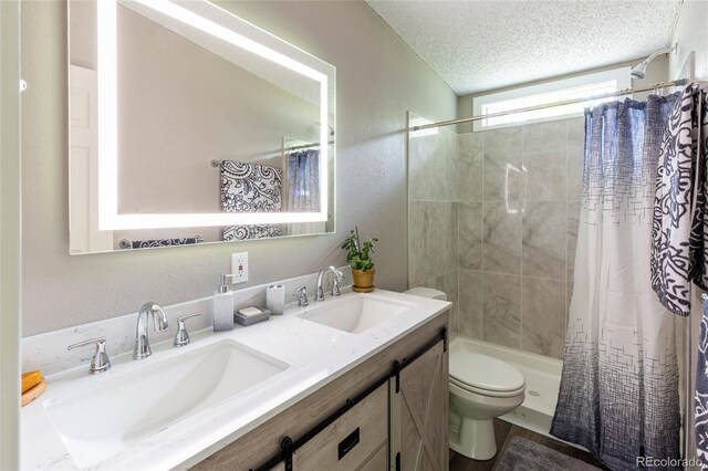910 W Main St, Buena Vista, CO 81211 - full bathroom featuring double vanity, a textured wall, a textured ceiling, and shower / bath combination with curtain