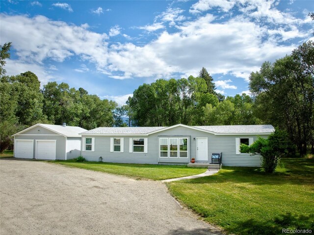 910 W Main St, Buena Vista, CO 81211 - view of front of property featuring a detached garage and a front lawn