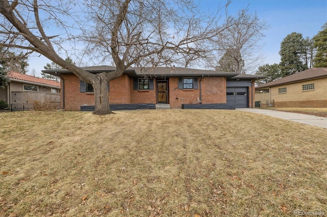 single story home with a garage, brick siding, fence, driveway, and a front yard