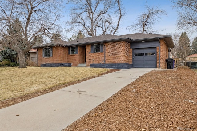 ranch-style house with central AC unit, concrete driveway, an attached garage, a front lawn, and brick siding