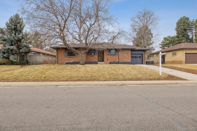 ranch-style home with an attached garage, brick siding, fence, driveway, and a front lawn