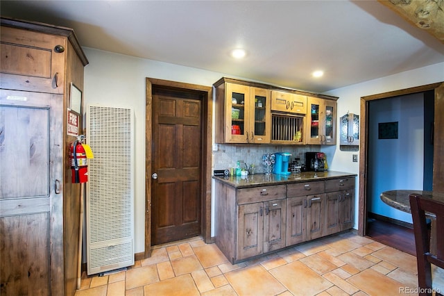 kitchen featuring tasteful backsplash and dark stone counters