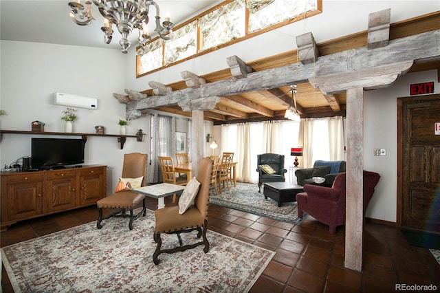 sitting room with a wall mounted AC, beamed ceiling, dark tile patterned flooring, and a notable chandelier