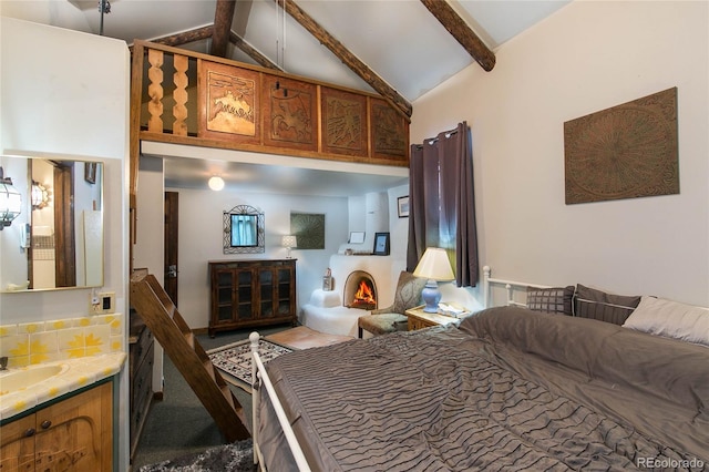 bedroom featuring beamed ceiling, high vaulted ceiling, and sink